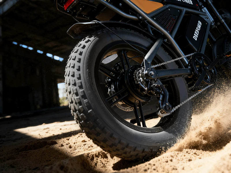QS7 fat tyre kicking up sand